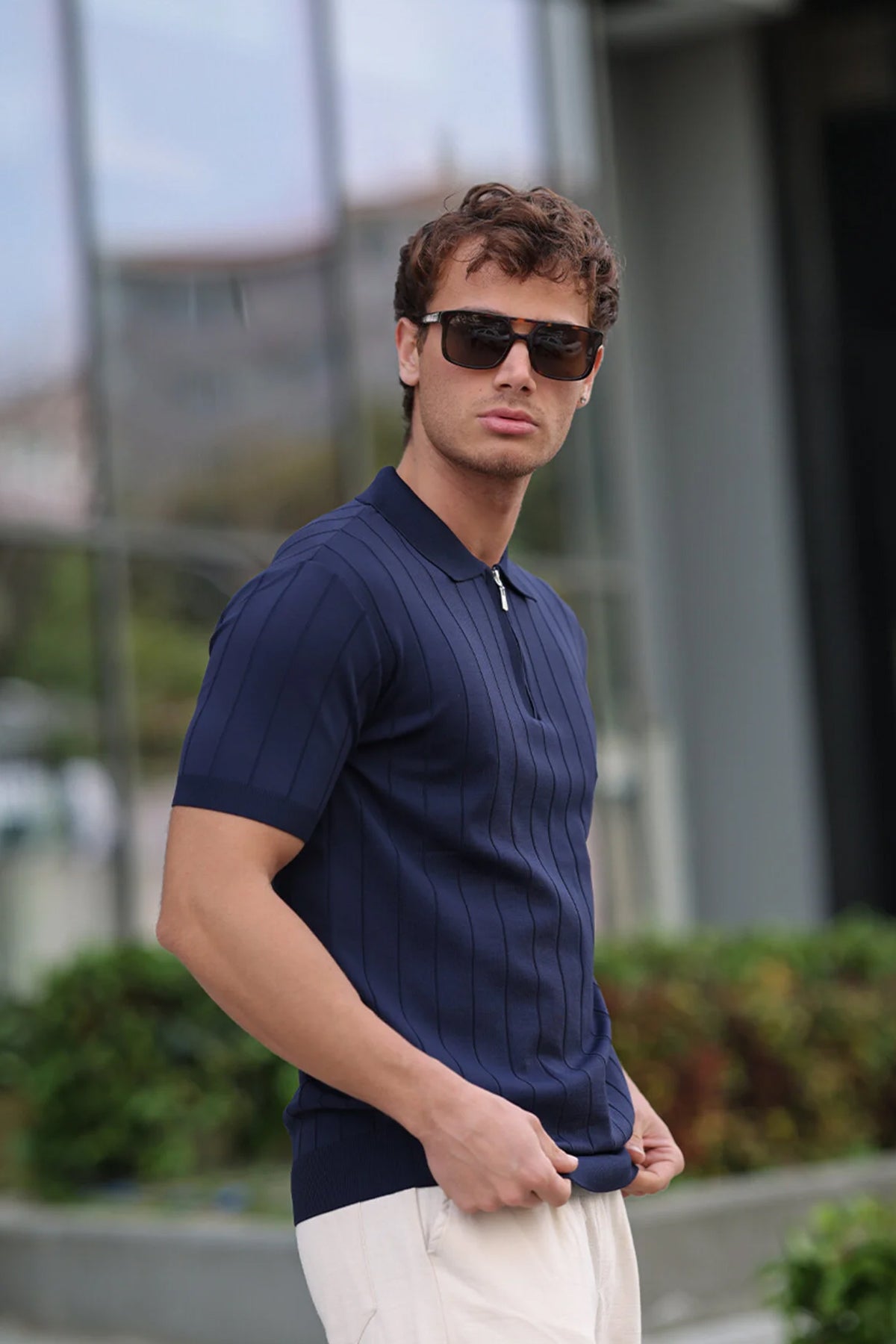 Men's navy polo shirt with short sleeves, ribbed collar, half-zip front