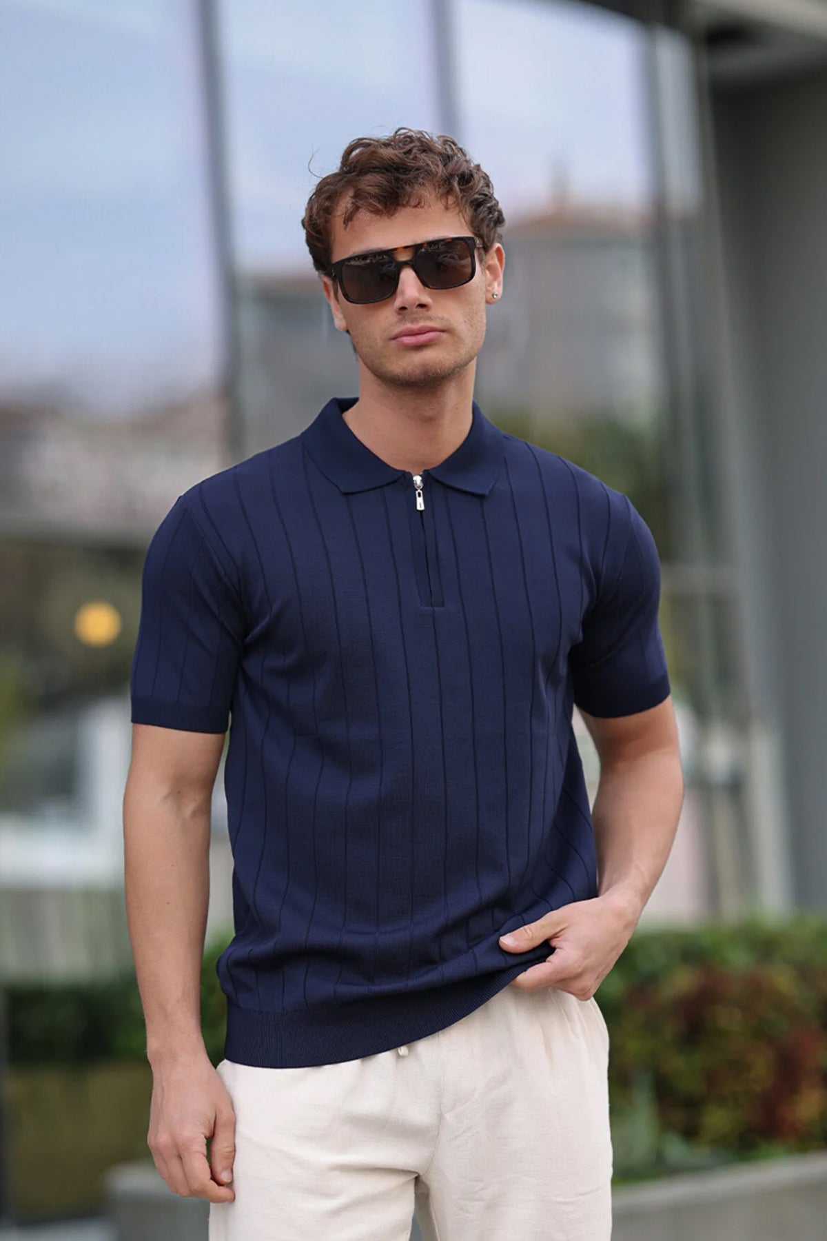 Men's navy knit half-zip polo shirt with vertical stripes and short sleeves