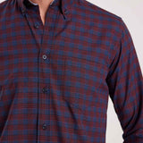 Men's plaid button-up shirt front in dark navy with rust-orange checks and buttons