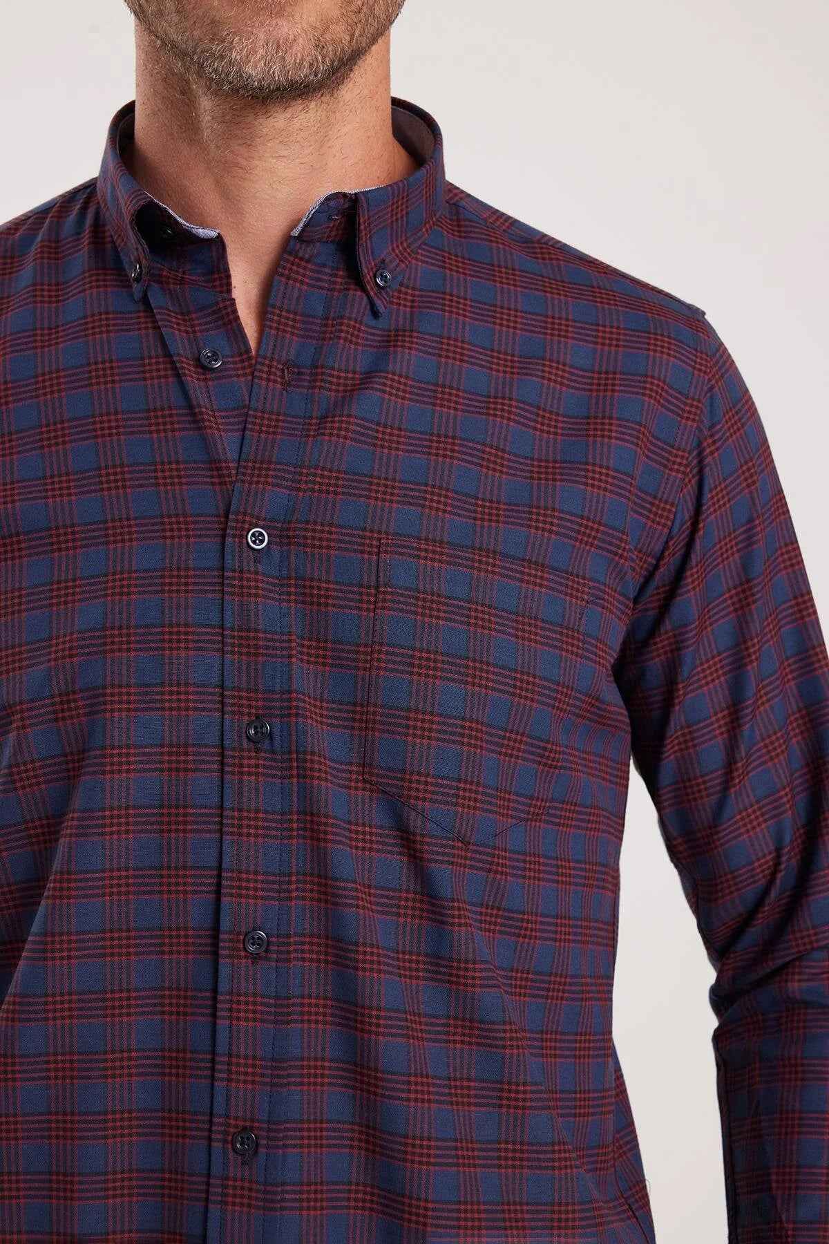 Men's plaid button-up shirt front in dark navy with rust-orange checks and buttons