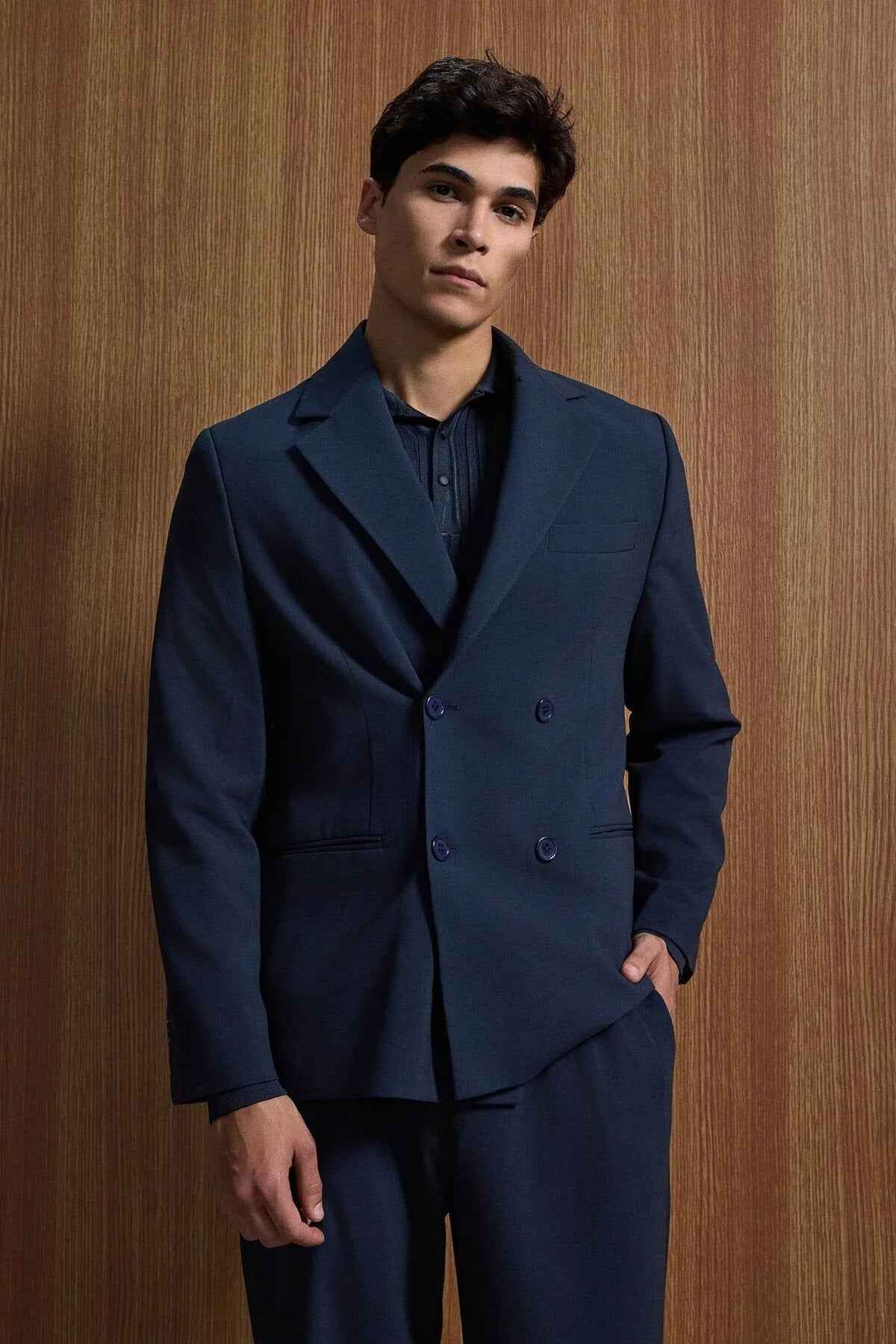 Navy double-breasted suit jacket and trousers, peak lapels