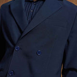 Navy double-breasted suit jacket with buttoned cuffs and chest welt pocket
