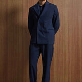 Navy double-breasted suit jacket with matching trousers, relaxed stance