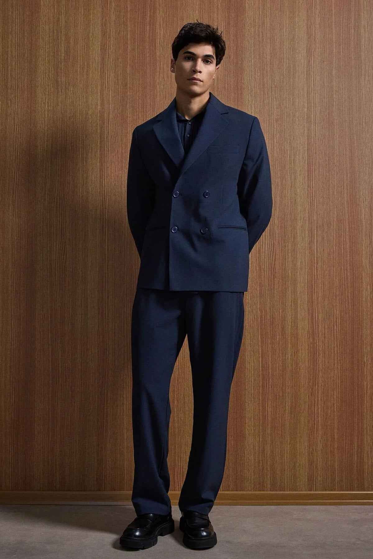 Navy double-breasted suit jacket with matching trousers, relaxed stance