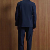 Navy suit jacket and trousers, back view