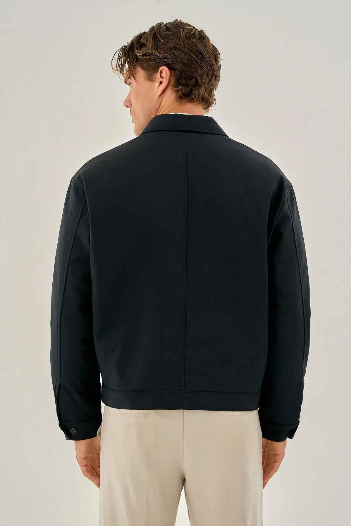 Men's dark blue back of zip-front jacket with stand collar and ribbed hem