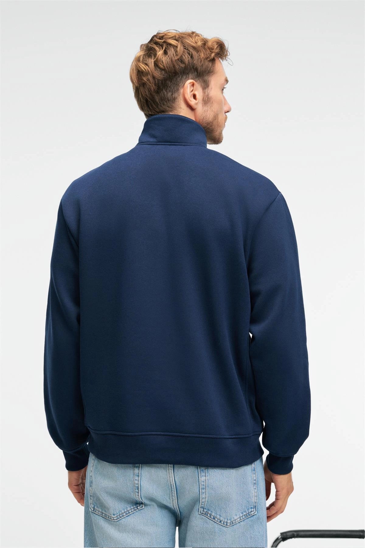Navy blue relaxed-fit sweatshirt with stand collar and zippered front, back view