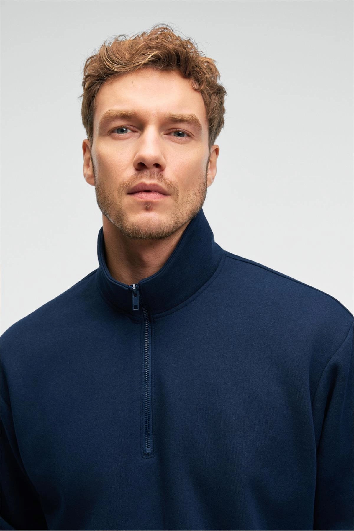 Navy blue zip stand-collar sweatshirt with close-up of half-zip and collar