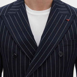 Men's navy pinstripe suit jacket lapels with double-breasted button closure