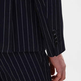 Men's navy pinstripe suit jacket sleeve and matching trouser leg