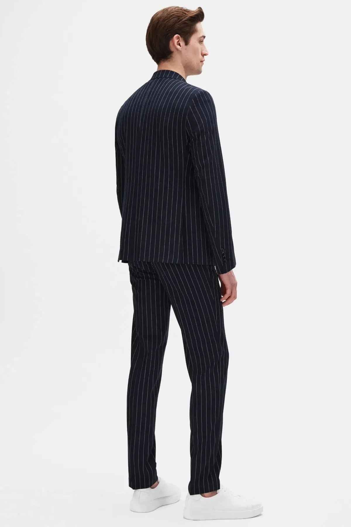 Men's navy pinstripe suit jacket and trousers, side view