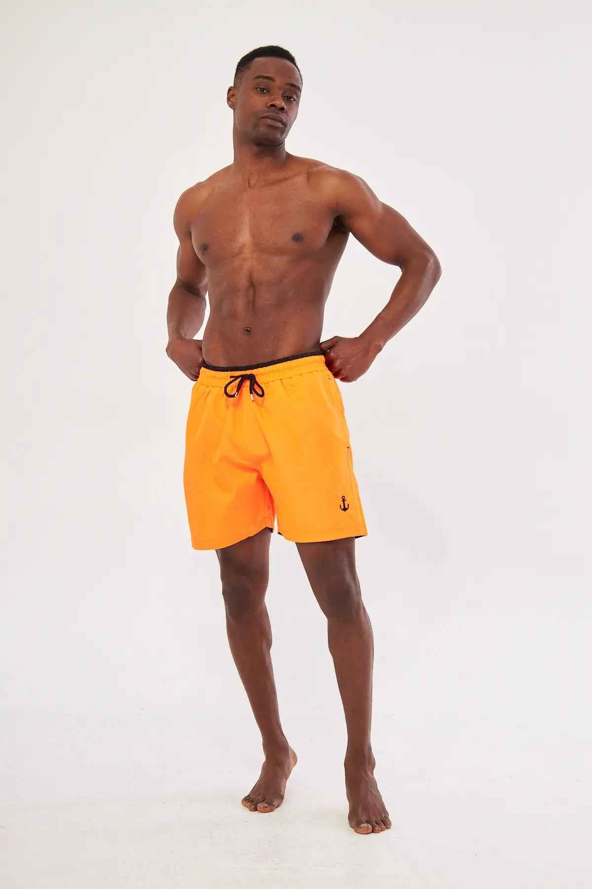 Men's orange swim shorts with black drawstring, standing front view