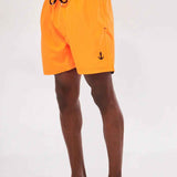 Men's orange swim shorts with black drawstring and anchor emblem on leg