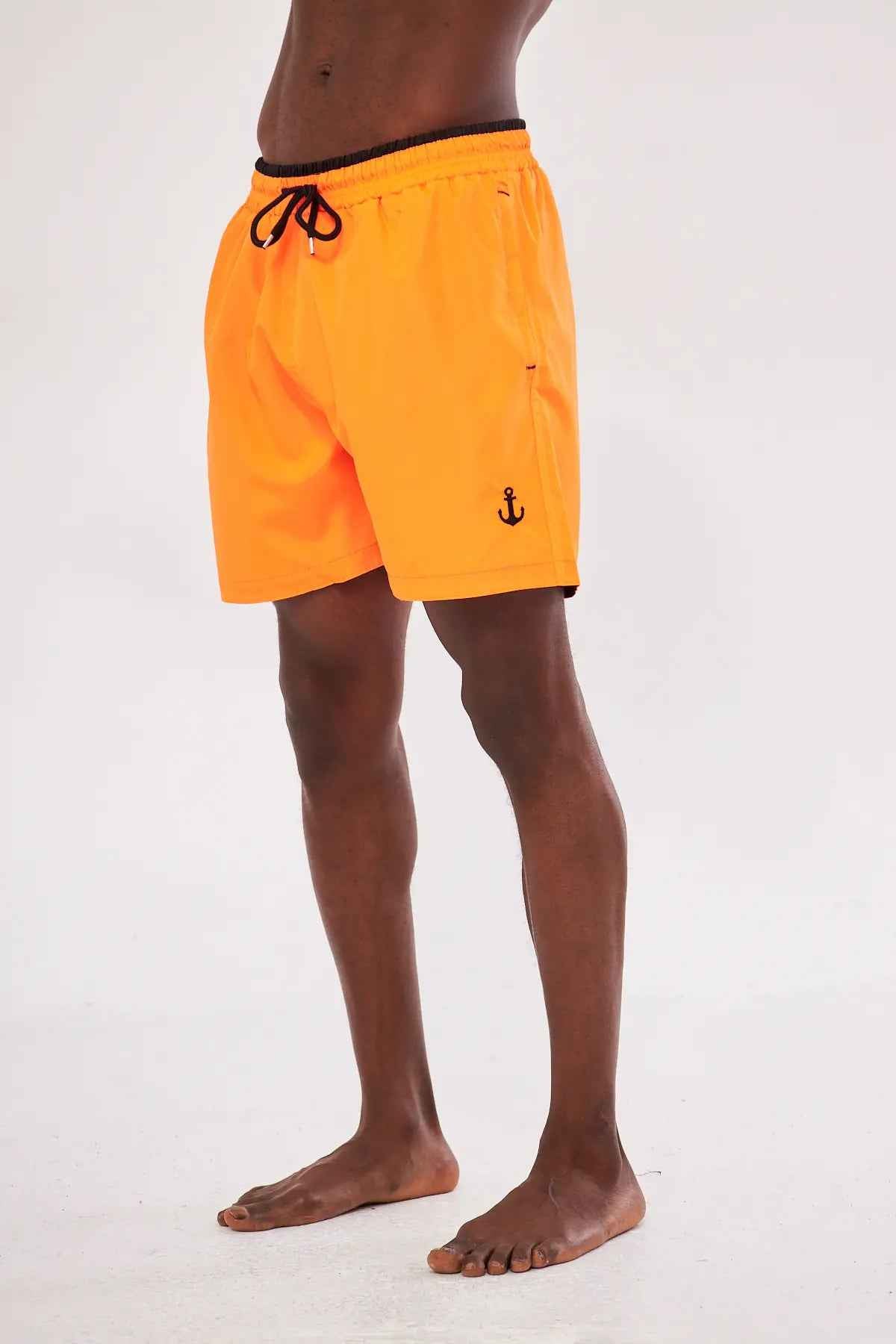 Men's orange swim shorts with black drawstring and anchor emblem on leg
