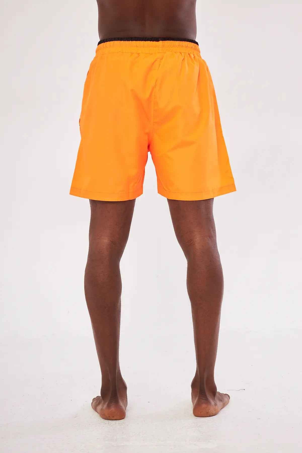 Men's orange swim shorts with black drawstring, back view, above-knee length