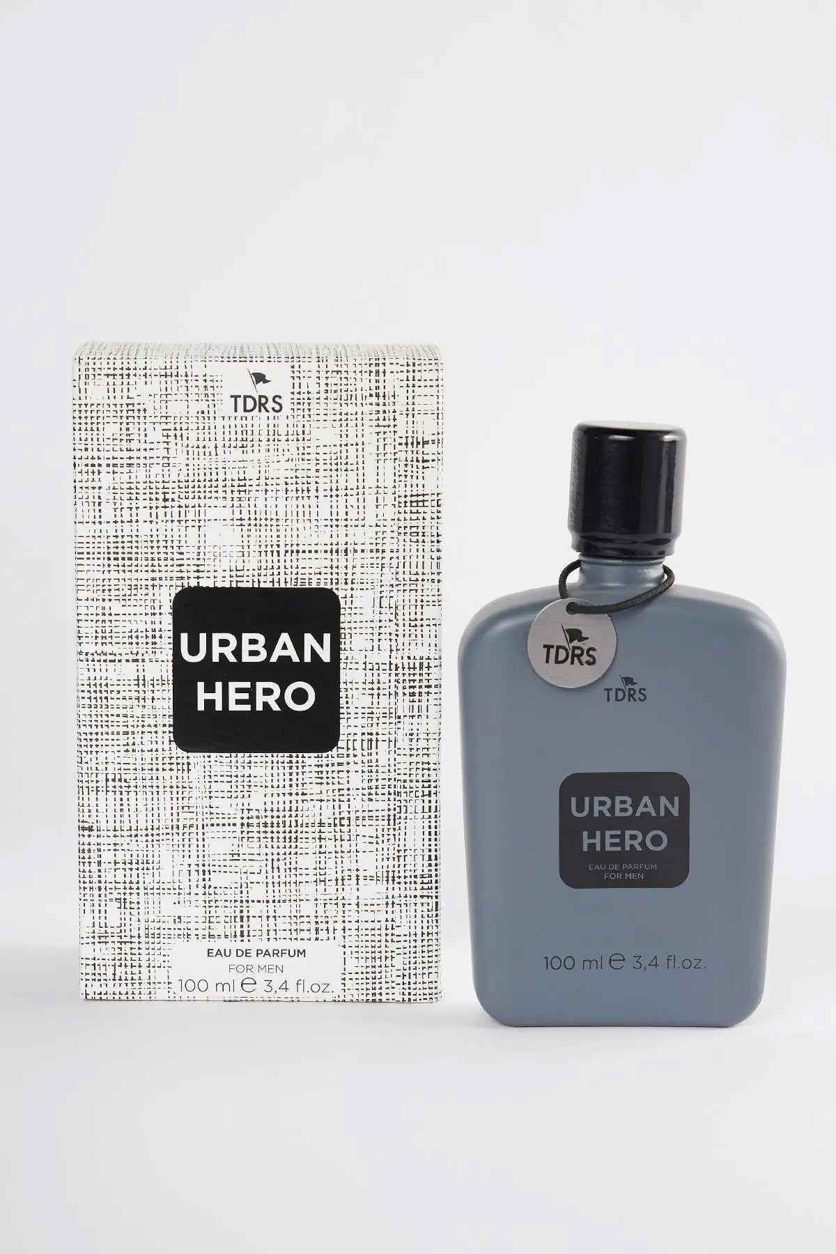 Men's eau de parfum box beside Urban Hero bottle with dark cap, 100 ml