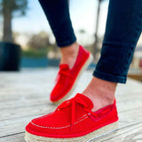 Red espadrille shoes with ribbon bow, low jute wedge sole and stitched trim