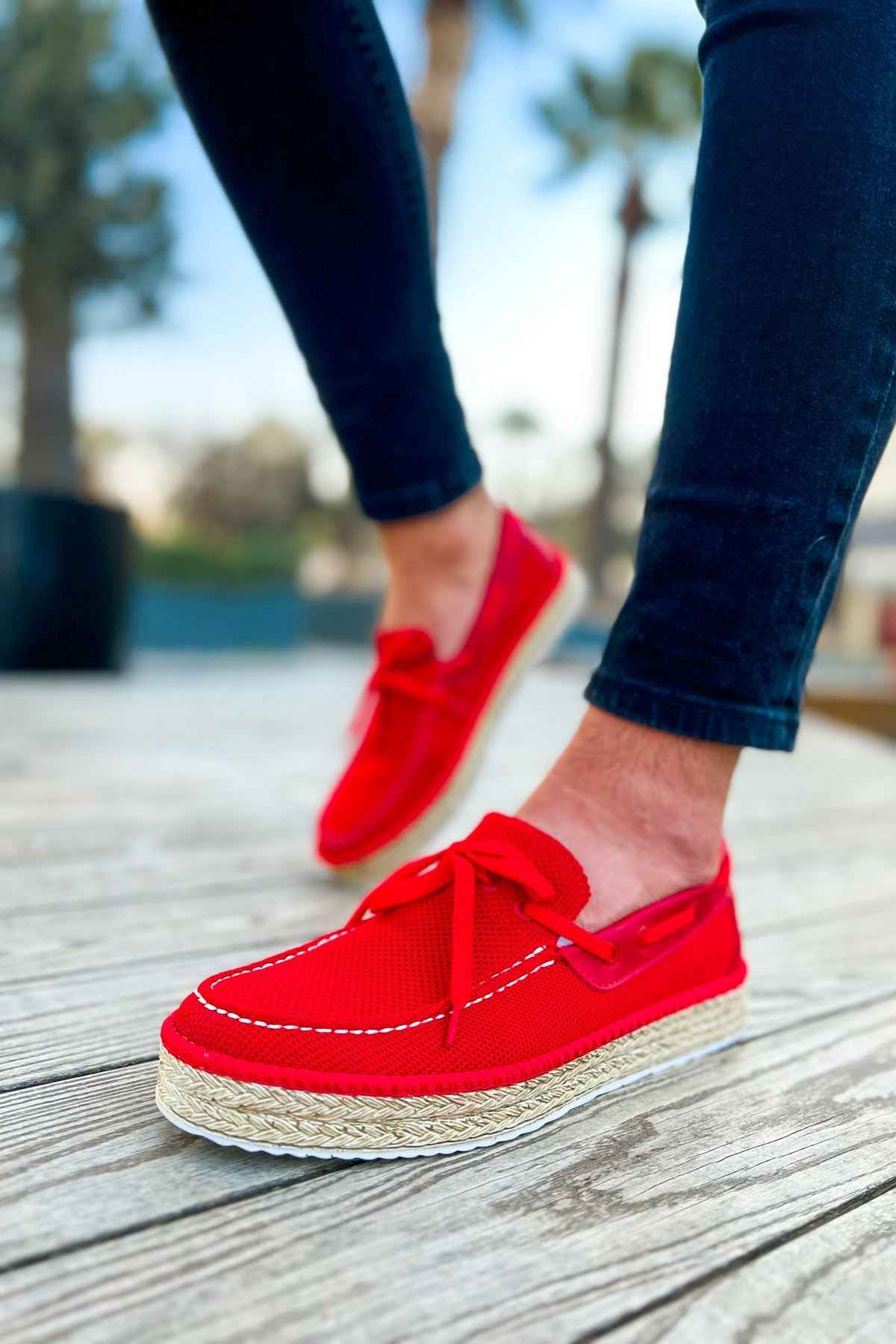 Red espadrille shoes with ribbon bow, low jute wedge sole and stitched trim