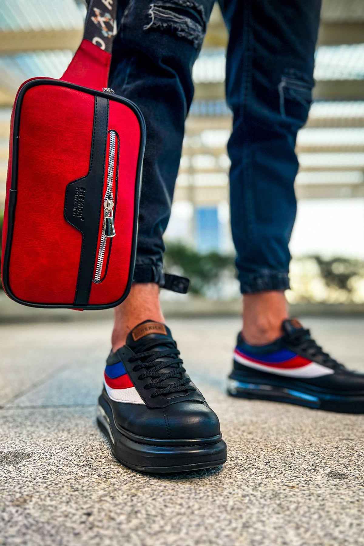 Red tablet bag with black trim and front zipper