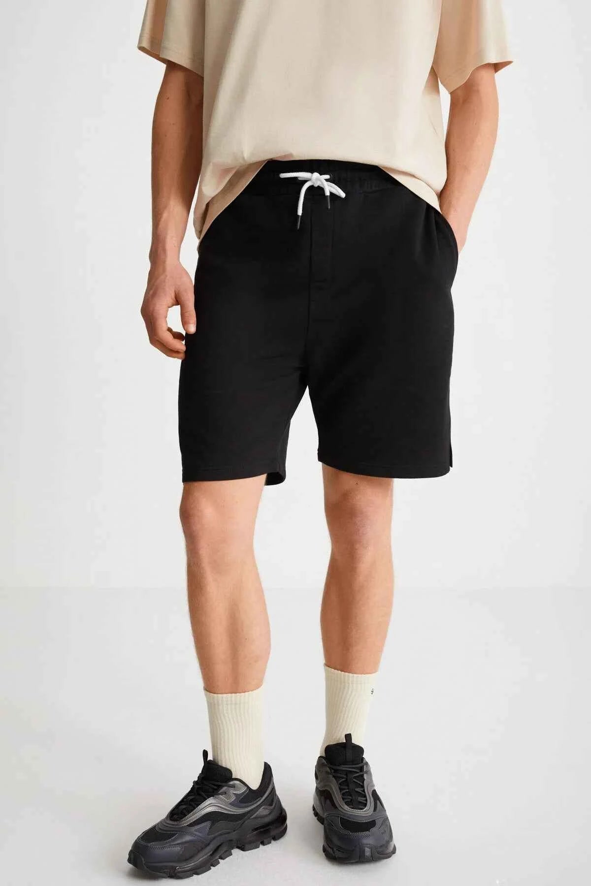 Black bermuda shorts, back view, drawstring waist and straight hem