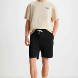 Black bermuda shorts with white drawstring, knee-length fit