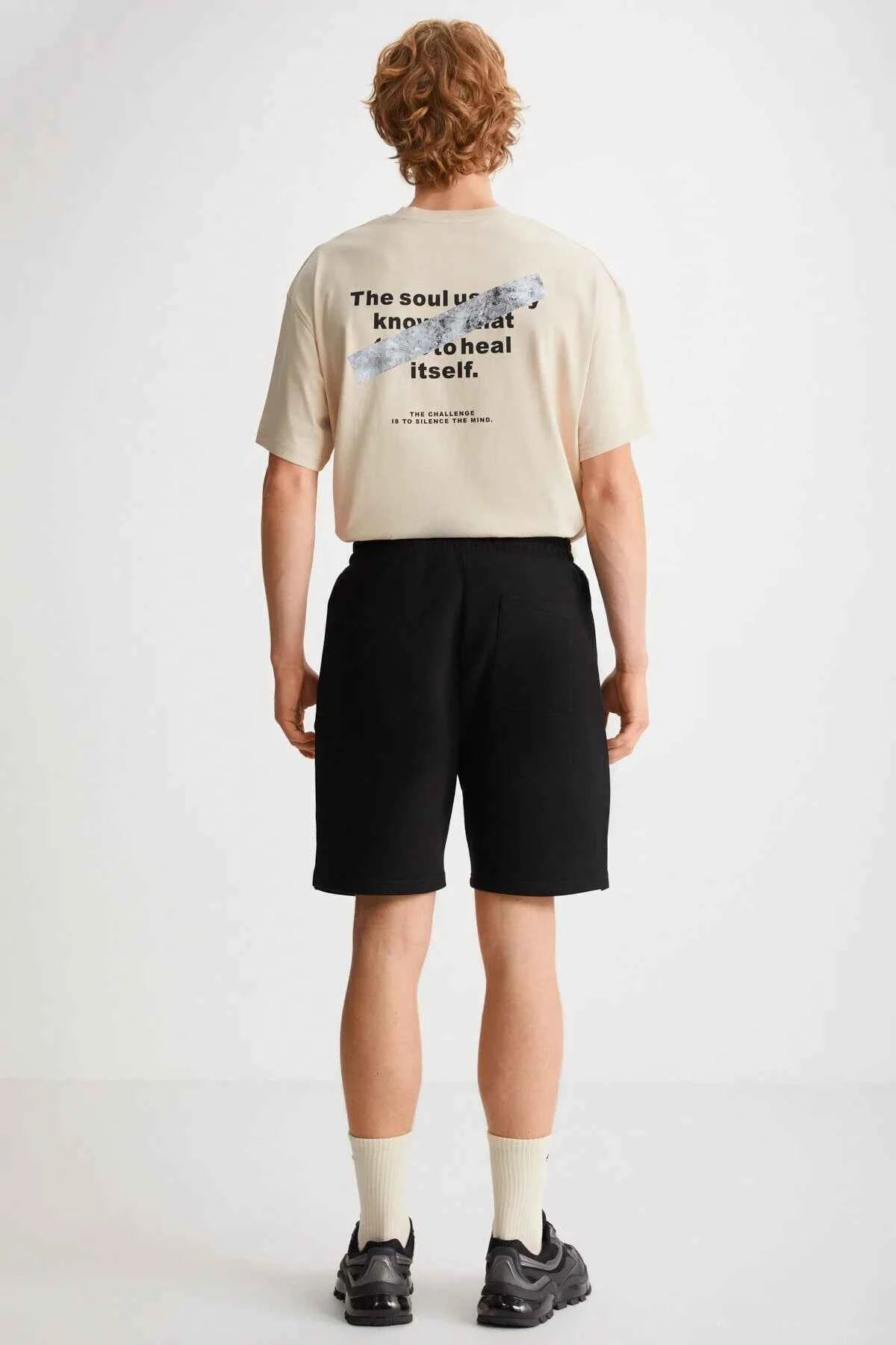 Black bermuda shorts with drawstring waist and side pockets