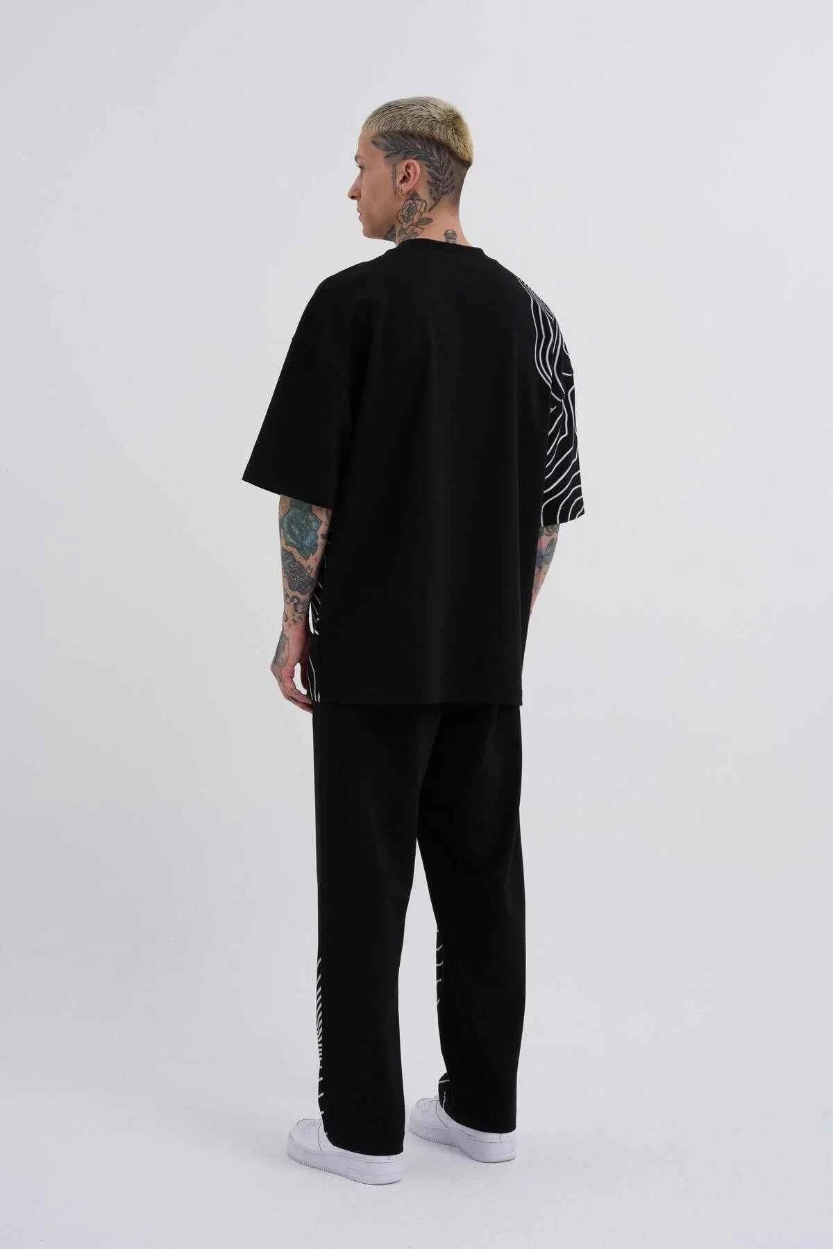 Men's oversize black T-shirt, back view, with white stripe panel graphic