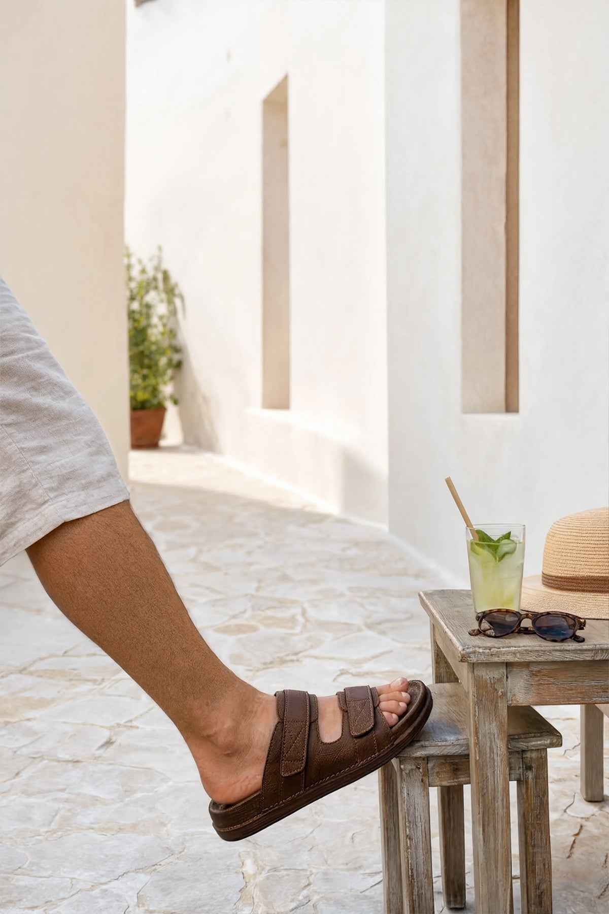 Tan slide sandals with single wide strap and cushioned footbed