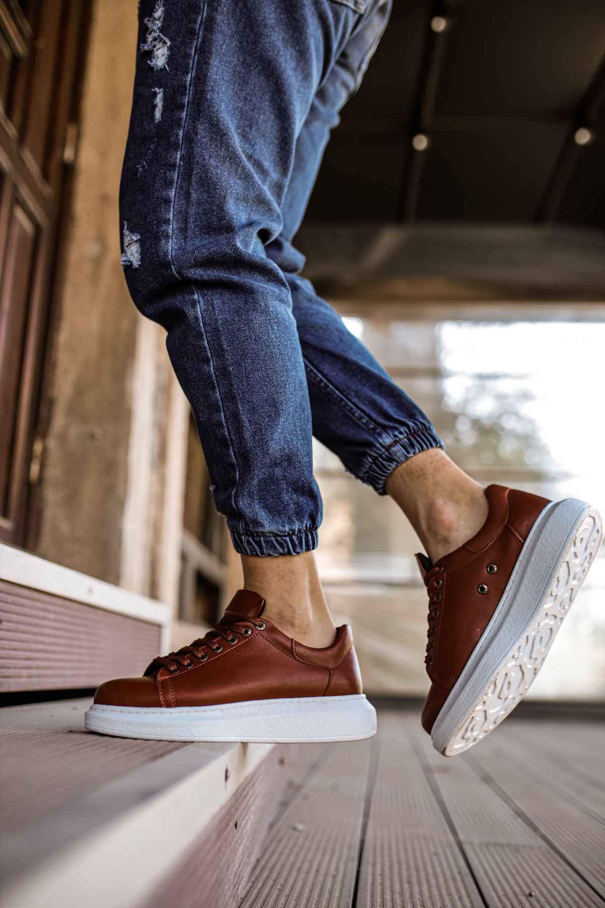 Men's tan sneakers with white sole and visible sidewall tread