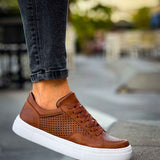 Tan Lix sneakers on footpath, low-top lace-up with perforated detail