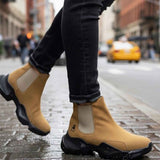 Tan suede ankle boots with side elastic panels and black tread sole, pull-on style.