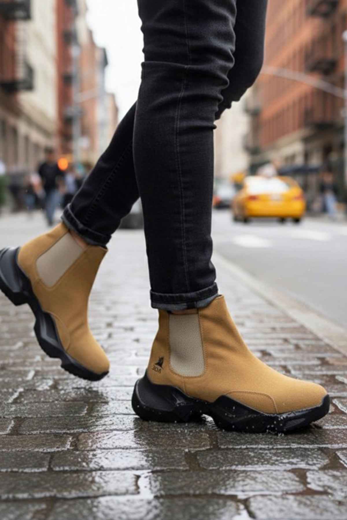 Tan suede ankle boots with side elastic panels and black tread sole, pull-on style.