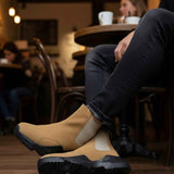 Tan suede ankle boots with black tread outsole and side elastic gore, full side view.