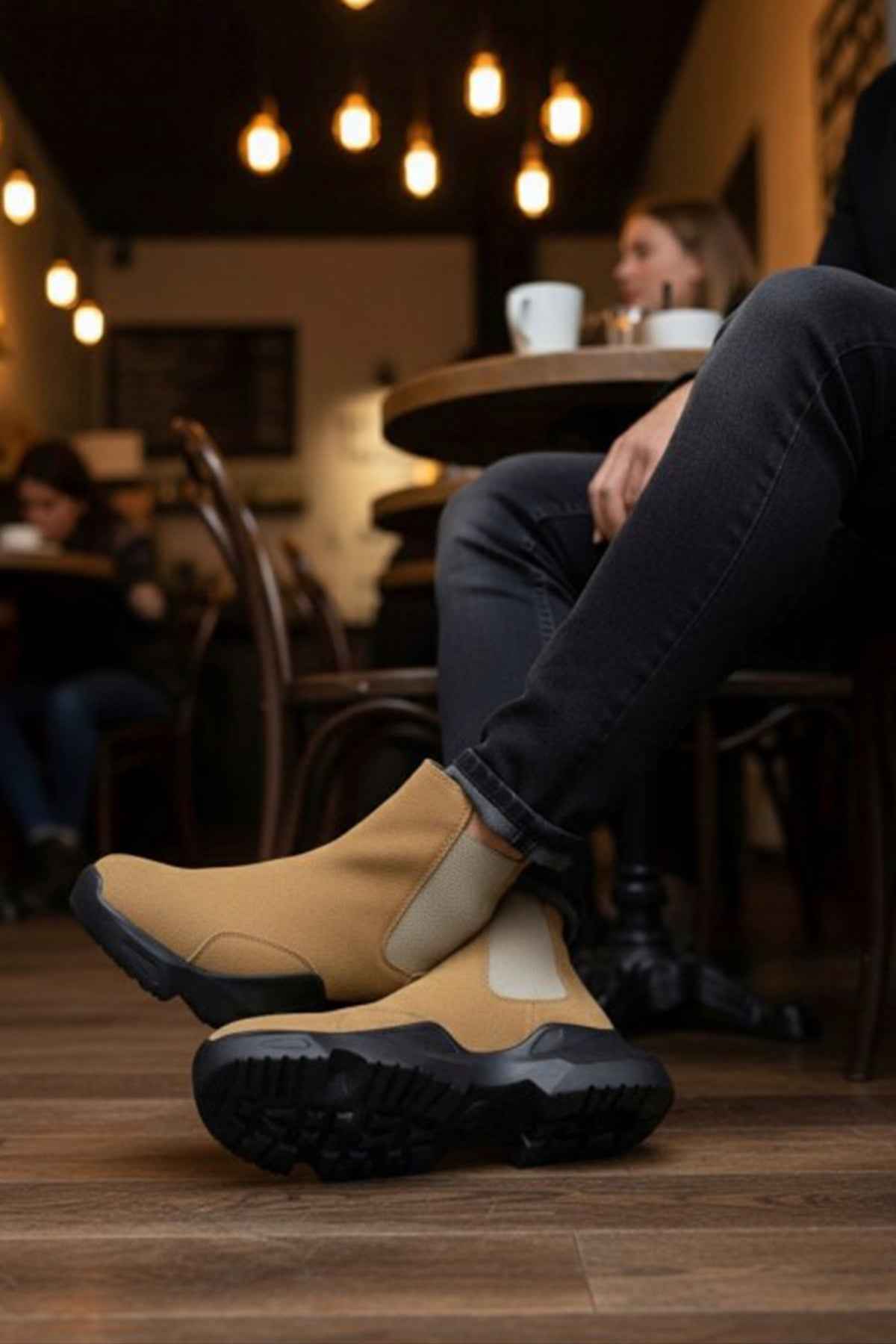 Tan suede ankle boots with black tread outsole and side elastic gore, full side view.