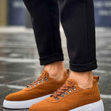 Tan suede sneakers side view, lace-up with metal eyelets and white sole