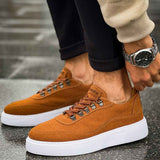 Tan suede lace-up sneakers with metal eyelets and white sole