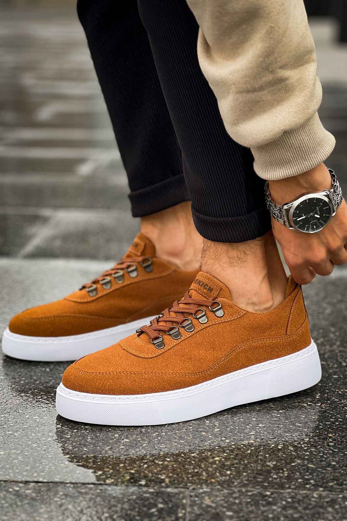 Tan suede lace-up sneakers with metal eyelets and white sole