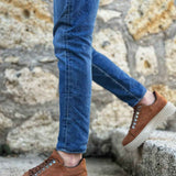 Men's tan suede sneakers with lace-up detail and textured rubber sole
