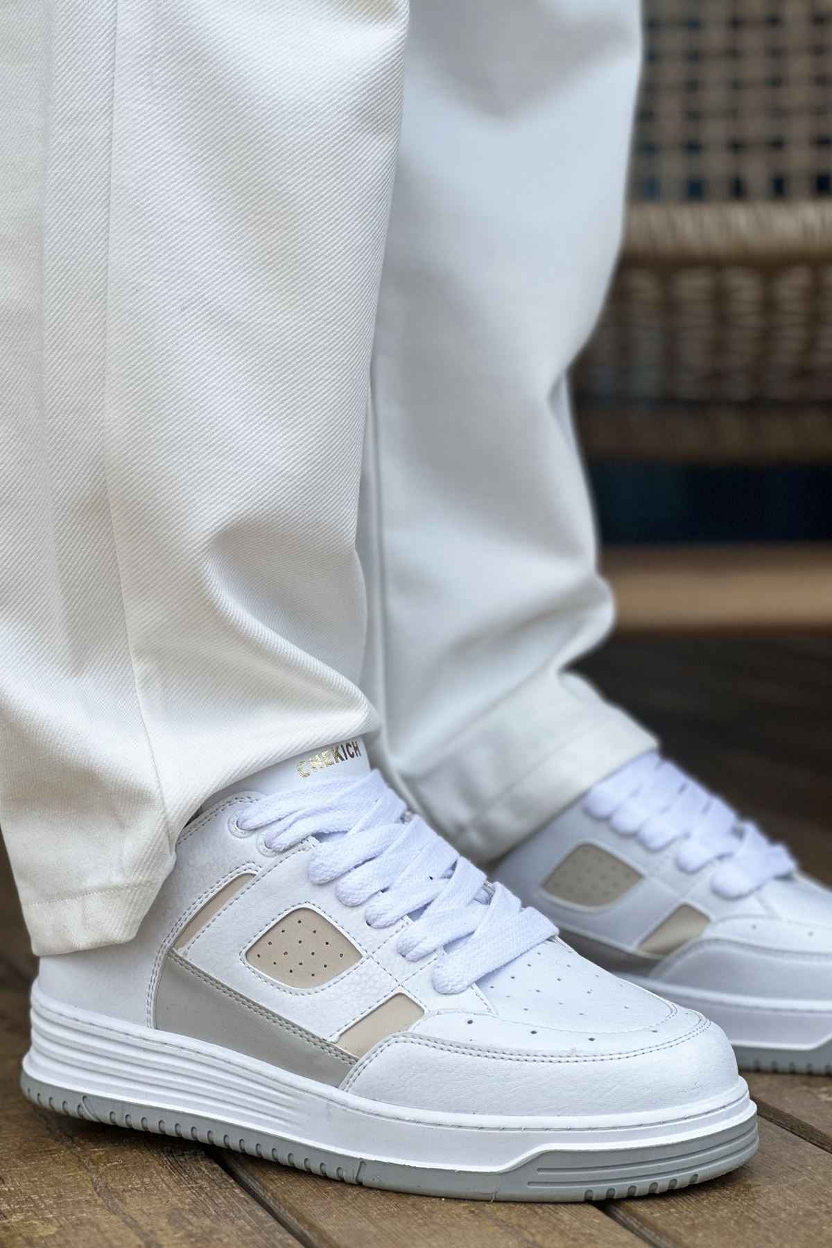 Men's white and beige lace-up sneakers with padded collar and gray rubber sole