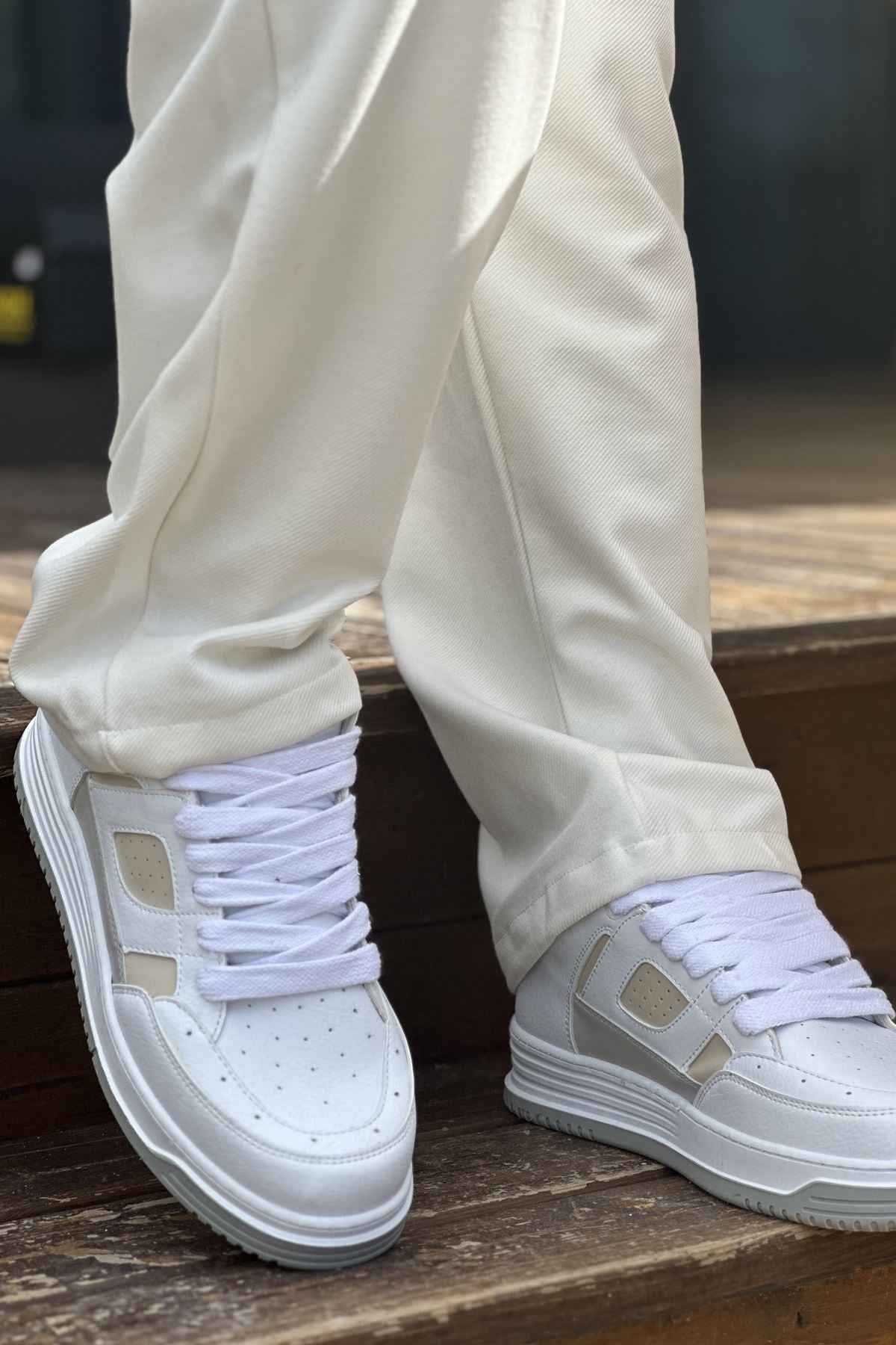 White and beige lace-up sneakers, front view with padded collar and tread sole