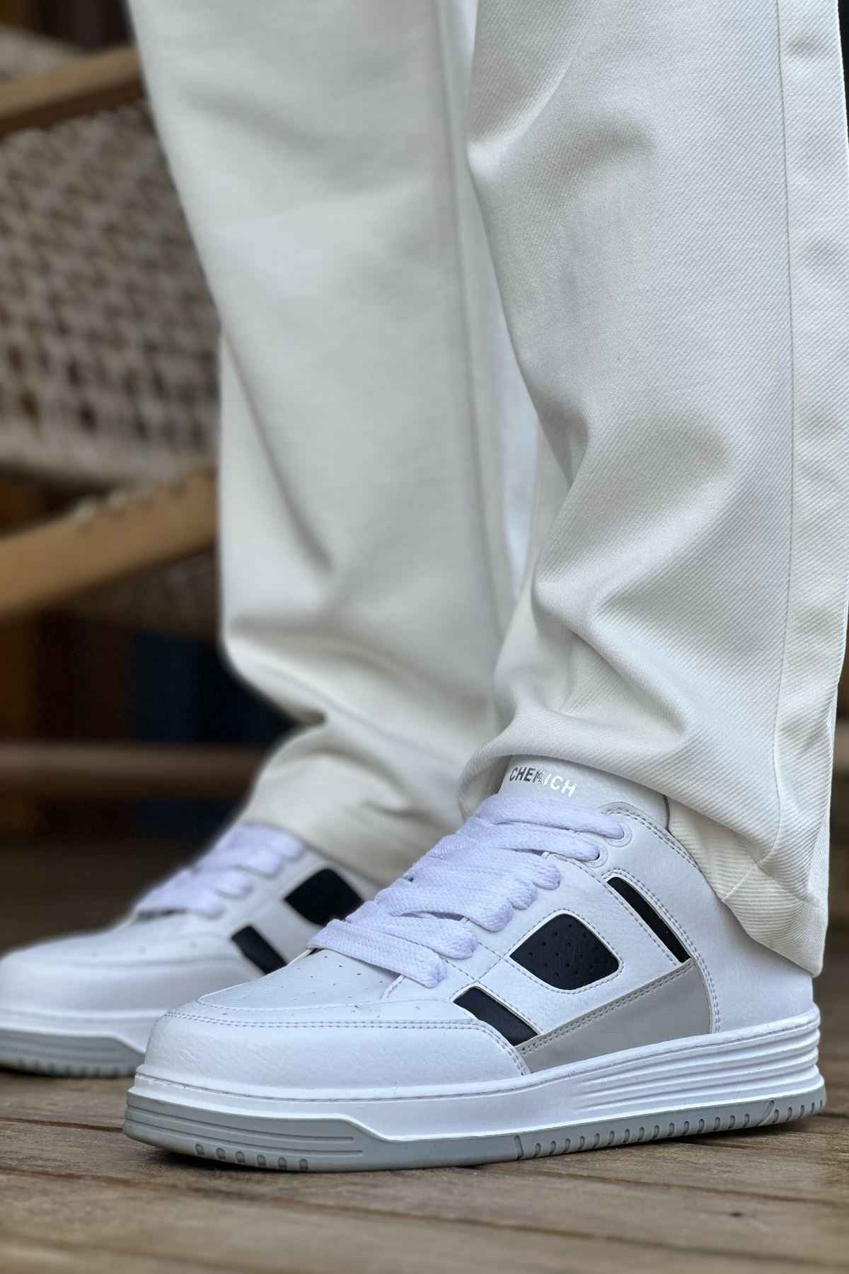 Men's white sneakers with black side panels and lace-up front