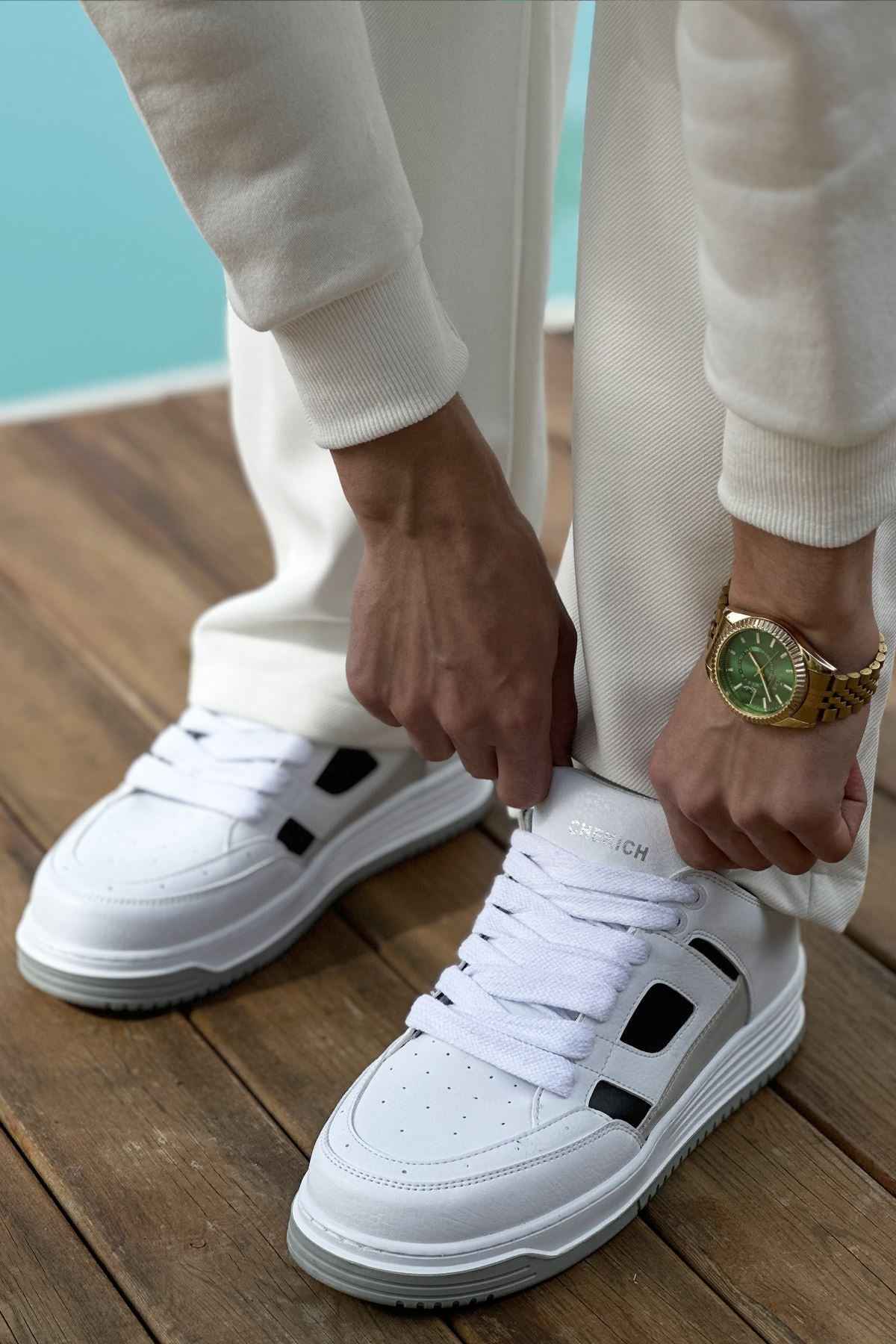 Men's white sneakers with black side patches and thick gray rubber sole