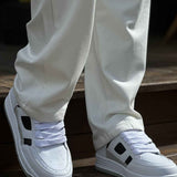 Men's white lace-up sneakers with black square side accents
