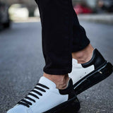 Men's two-tone sneakers with white leather-like uppers and black laces, side view