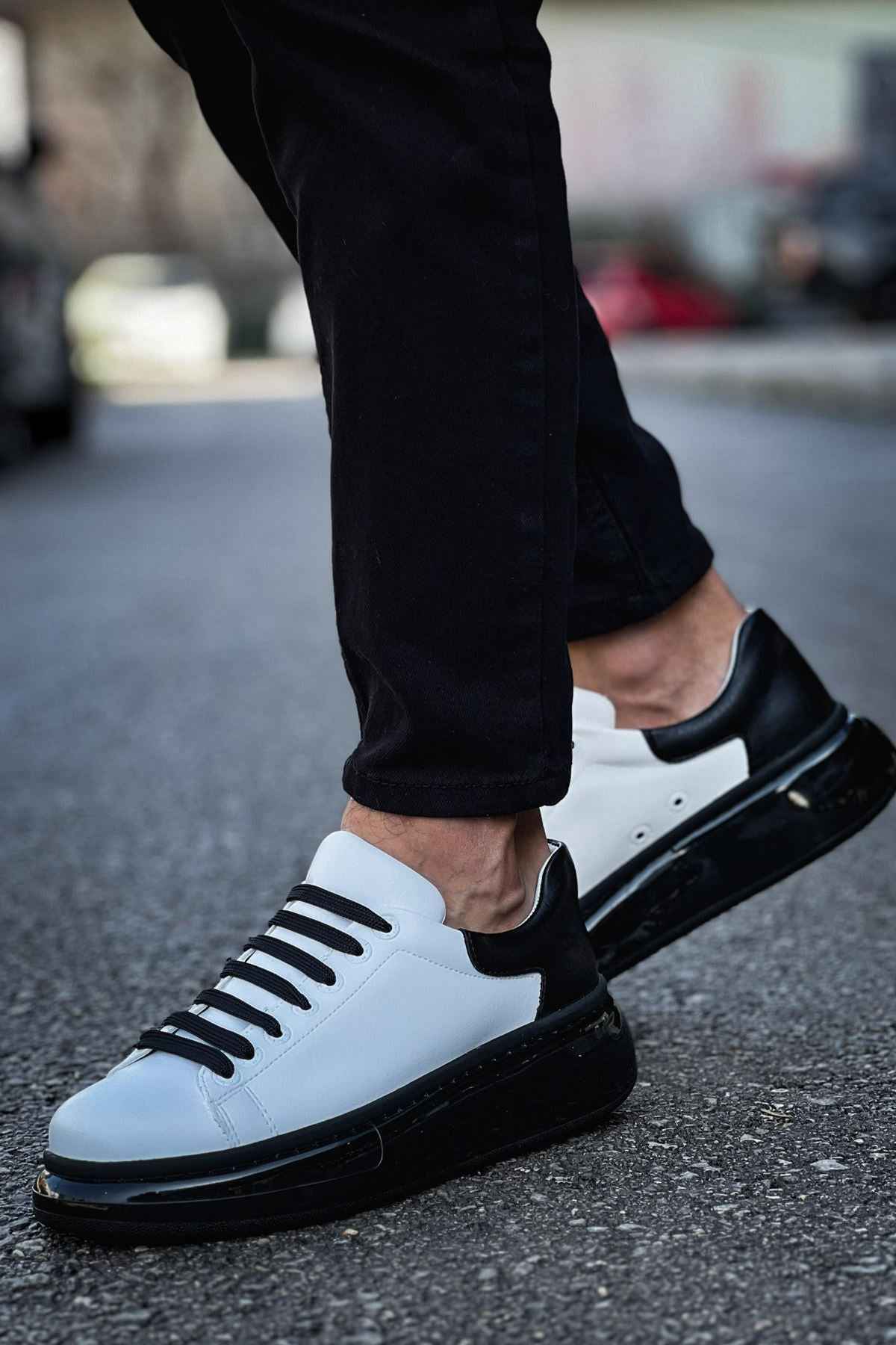 Men's two-tone sneakers with white leather-like uppers and black laces, side view