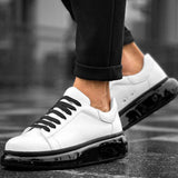 Low-top white sneakers with black lace-up front and thick black outsole