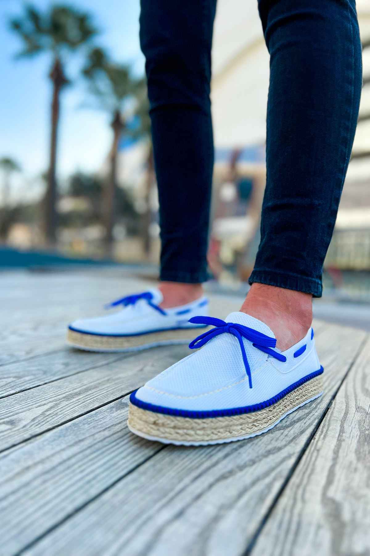 Pair of men's white espadrilles with blue lace-up and jute midsole detail
