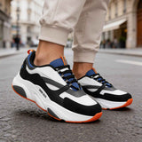 Men's lace-up sneakers, white and black uppers with blue panels; orange outsole.