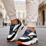 Men's lace-up sneakers, front/side view: white base, black swoosh, blue mesh, orange sole.