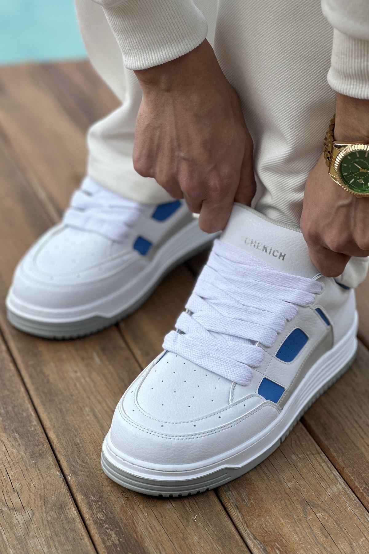 Men's white sneakers with blue side panels and white laces